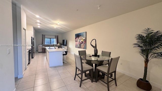 dining room with light tile patterned flooring and baseboards