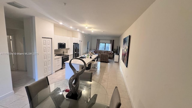 dining room with visible vents, baseboards, and light tile patterned flooring