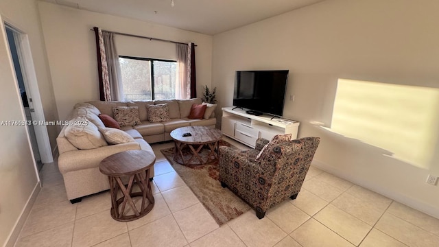 living area with light tile patterned floors and baseboards