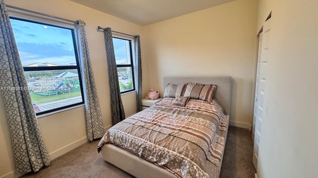 carpeted bedroom featuring baseboards