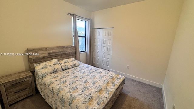 bedroom with a closet, baseboards, and dark colored carpet