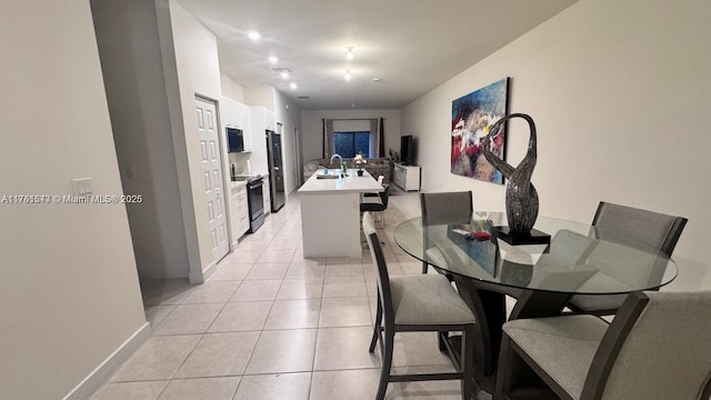 dining room with light tile patterned floors, baseboards, and recessed lighting