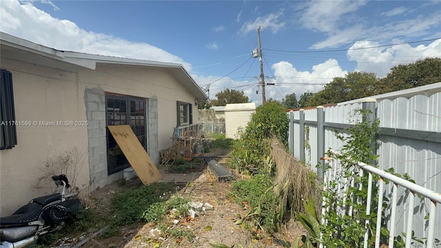 view of yard featuring an outdoor structure and a fenced backyard