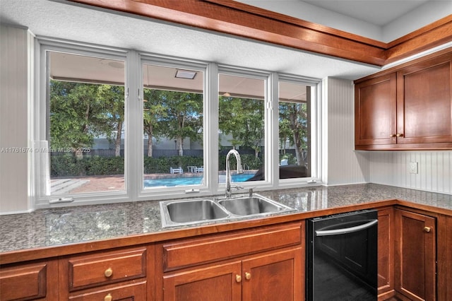 kitchen with a wealth of natural light, dishwasher, brown cabinetry, and a sink