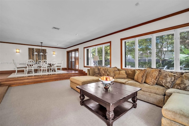 carpeted living area featuring visible vents and ornamental molding