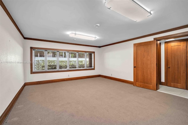 unfurnished room featuring crown molding, light colored carpet, and baseboards