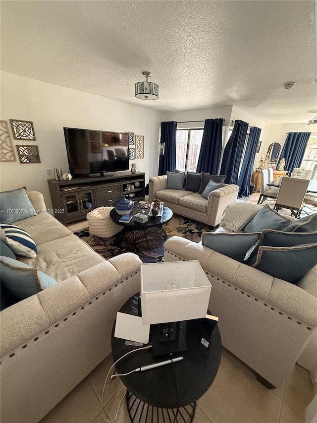 tiled living area featuring a textured ceiling