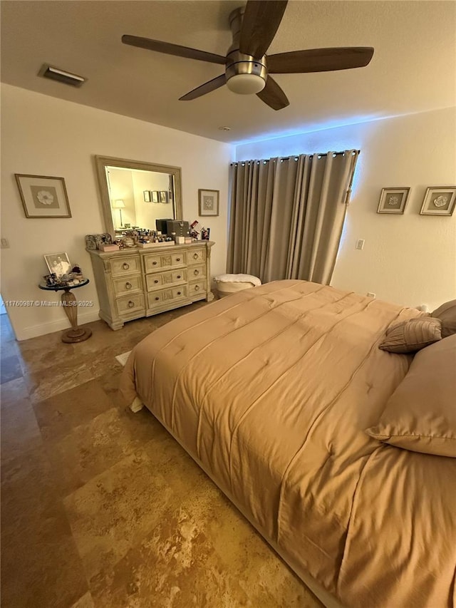 bedroom with visible vents, baseboards, and ceiling fan