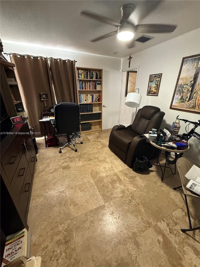 office area with visible vents and ceiling fan