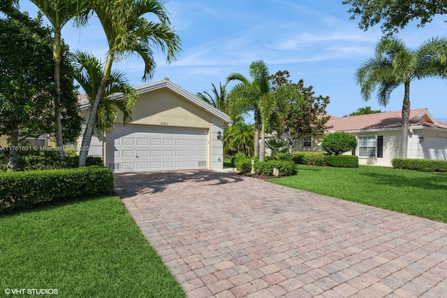 8163 Montserrat Pl, Wellington, FL 33414 - view of front of property featuring decorative driveway, stucco siding, a front lawn, and a garage