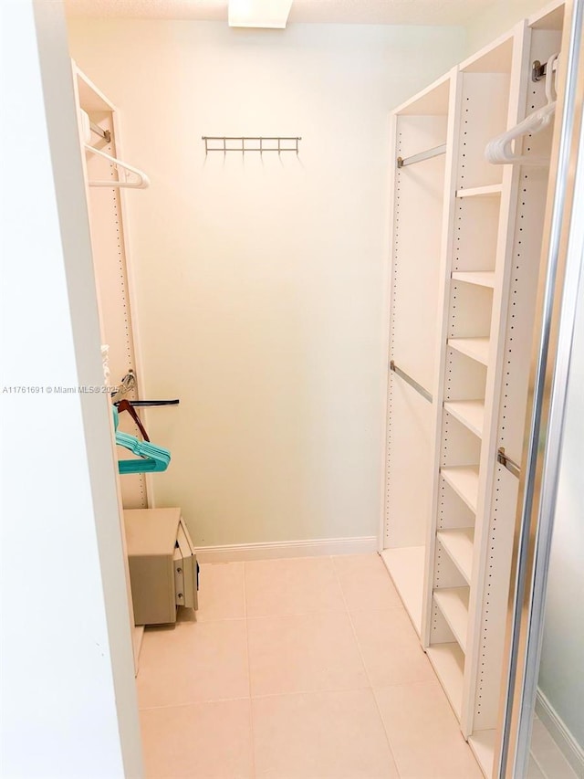 walk in closet featuring light tile patterned floors