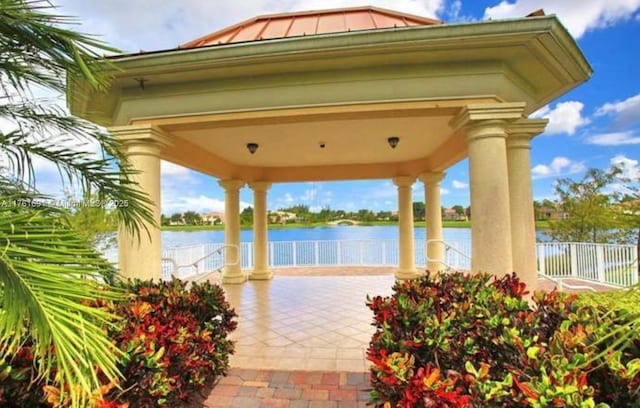 exterior space with fence and a water view