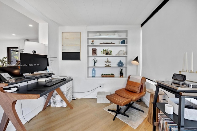 home office featuring built in features and wood finished floors