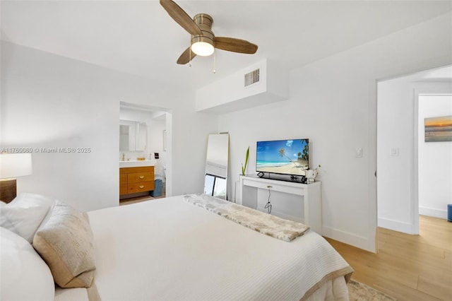 bedroom with visible vents, ceiling fan, baseboards, light wood-type flooring, and ensuite bathroom