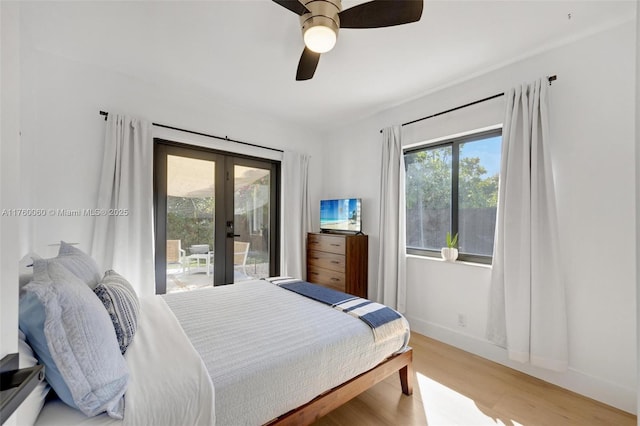 bedroom featuring baseboards, light wood finished floors, ceiling fan, access to exterior, and french doors