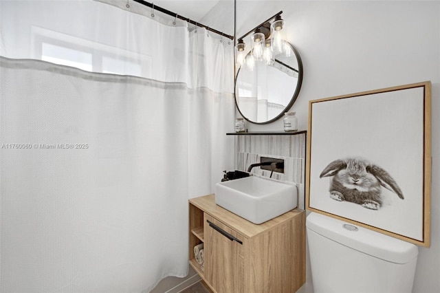 bathroom featuring vanity, toilet, and a shower with curtain