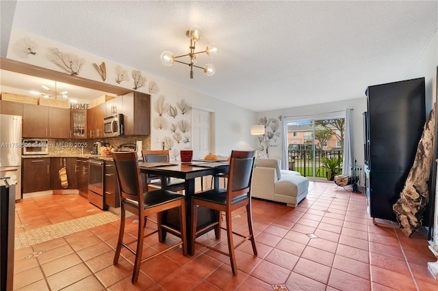 4705 NW 7th St Unit 101-7, Miami, FL 33126 - dining area with a chandelier, a textured ceiling, and light tile patterned flooring