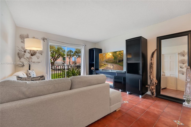 living room with a textured ceiling and tile patterned flooring