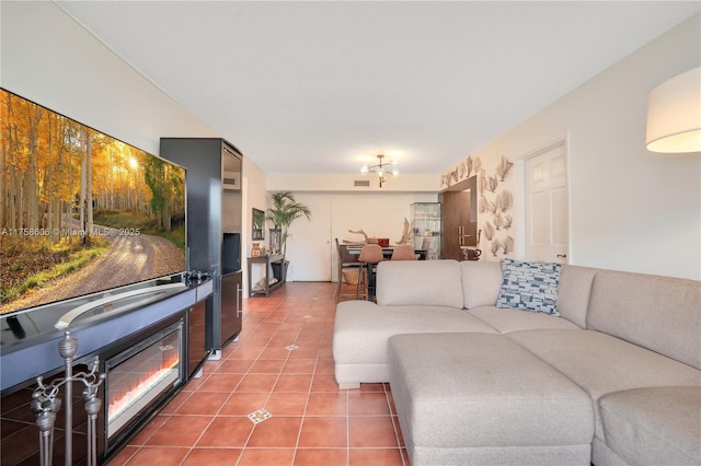 living room featuring tile patterned floors and a glass covered fireplace