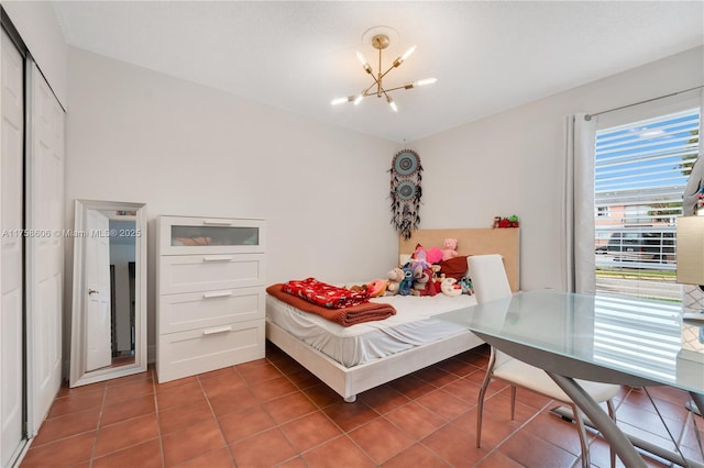 tiled bedroom featuring a chandelier