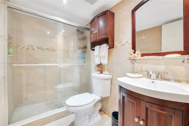 full bath featuring vanity, a stall shower, tile walls, toilet, and backsplash