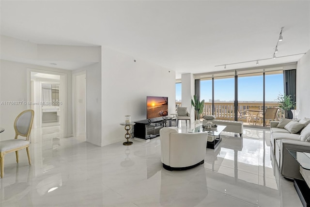 living area with track lighting and floor to ceiling windows