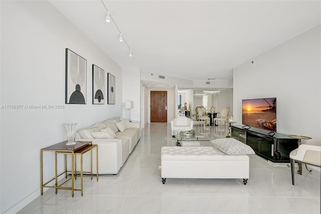 living area with light tile patterned floors, visible vents, and track lighting