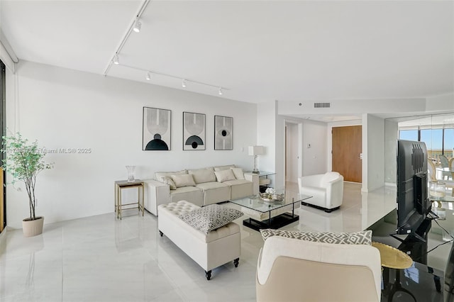 living room with track lighting and visible vents