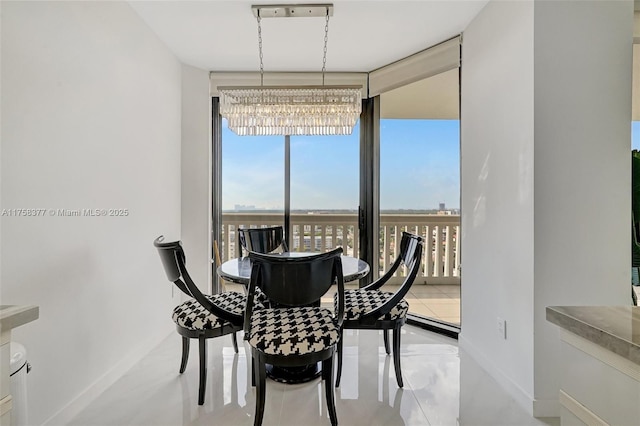 dining space featuring a notable chandelier and baseboards