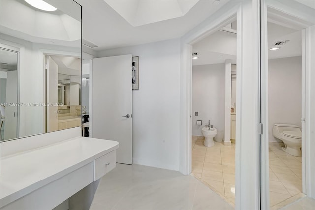 bathroom with visible vents, toilet, a bidet, tile patterned flooring, and vanity