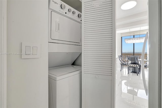 clothes washing area with laundry area and stacked washer / drying machine