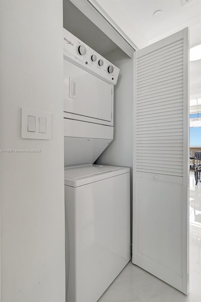 washroom with laundry area, visible vents, and stacked washing maching and dryer