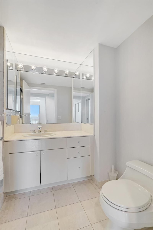 bathroom with tile patterned floors, toilet, and vanity