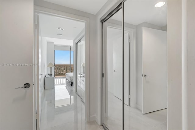 hall with light tile patterned floors