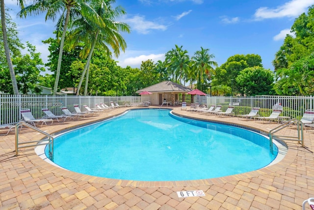 community pool featuring a patio and fence