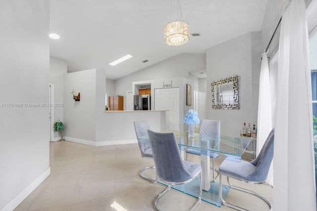 tiled dining area with baseboards, lofted ceiling, and visible vents