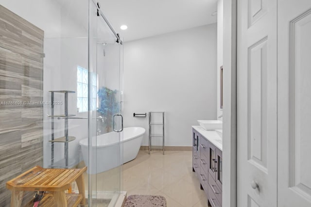 bathroom featuring double vanity, a freestanding bath, a shower stall, and tile patterned floors