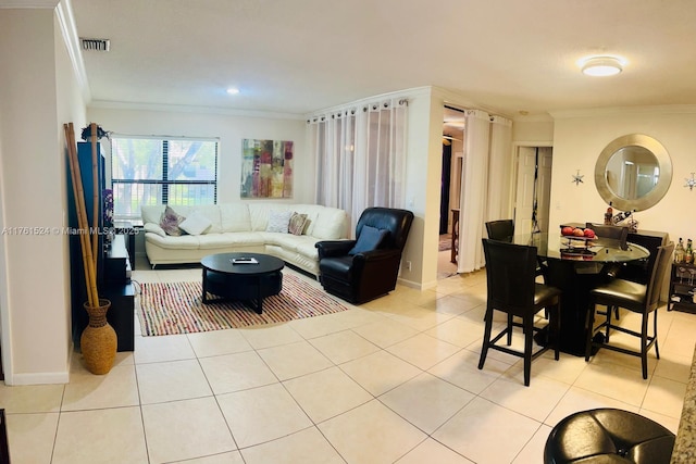 living room featuring light tile patterned floors, visible vents, crown molding, and baseboards