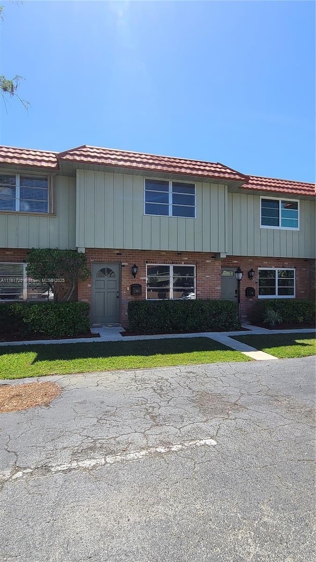 view of property featuring brick siding