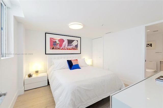 bedroom featuring baseboards and light wood-style floors