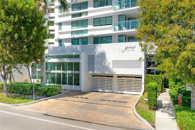 view of property featuring decorative driveway