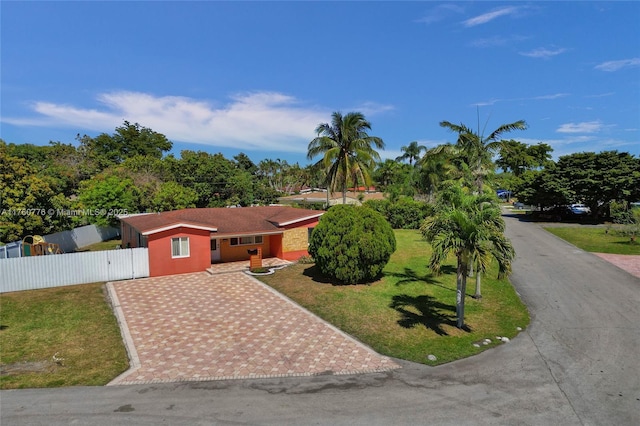 view of front of home featuring a front yard, a gate, decorative driveway, and fence