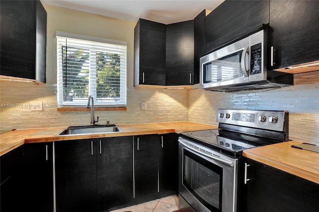 kitchen featuring appliances with stainless steel finishes and dark cabinetry