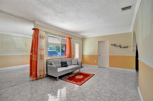 living room with arched walkways, visible vents, a textured ceiling, and ornamental molding