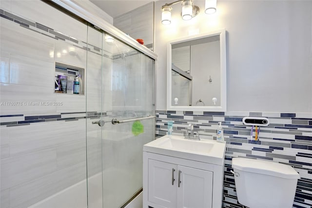 full bath featuring tile walls, toilet, and vanity