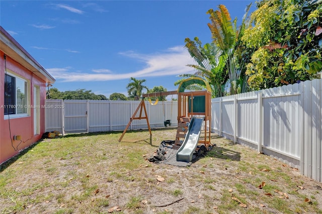 view of jungle gym featuring a yard and a fenced backyard