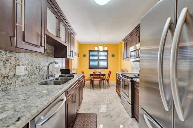 kitchen with marble finish floor, a sink, stainless steel appliances, dark brown cabinetry, and decorative backsplash