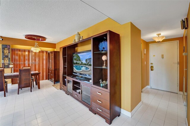 3800 Hillcrest Dr Unit 412, Hollywood, FL 33021 - living room with light tile patterned floors, a textured ceiling, and baseboards