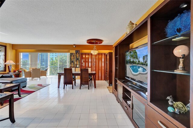 3800 Hillcrest Dr Unit 412, Hollywood, FL 33021 - dining room featuring a textured ceiling and light tile patterned floors