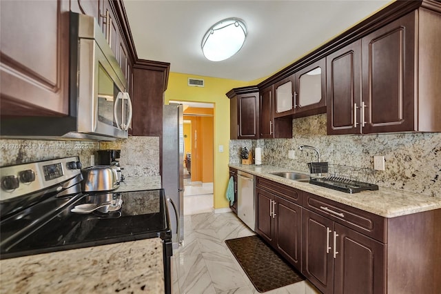 kitchen with visible vents, a sink, decorative backsplash, stainless steel appliances, and marble finish floor